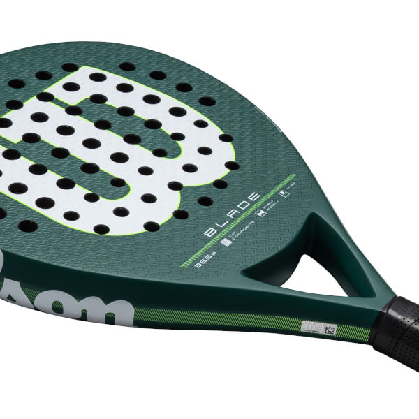 Close-up of a green Wilson Blade paddle showing the large "B" logo, black holes, and "365g" text.