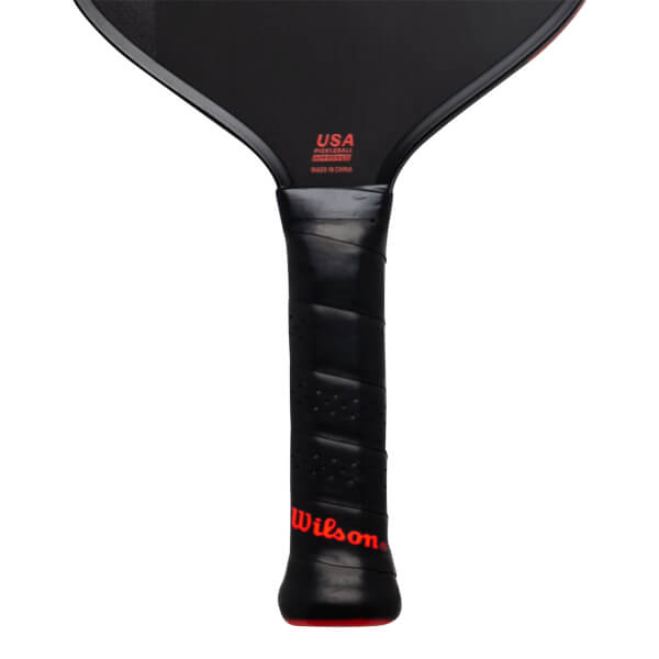 Close-up of the black handle and lower face featuring a red Wilson logo and red text stating USA PICKLEBALL APPROVED and MADE IN CHINA.