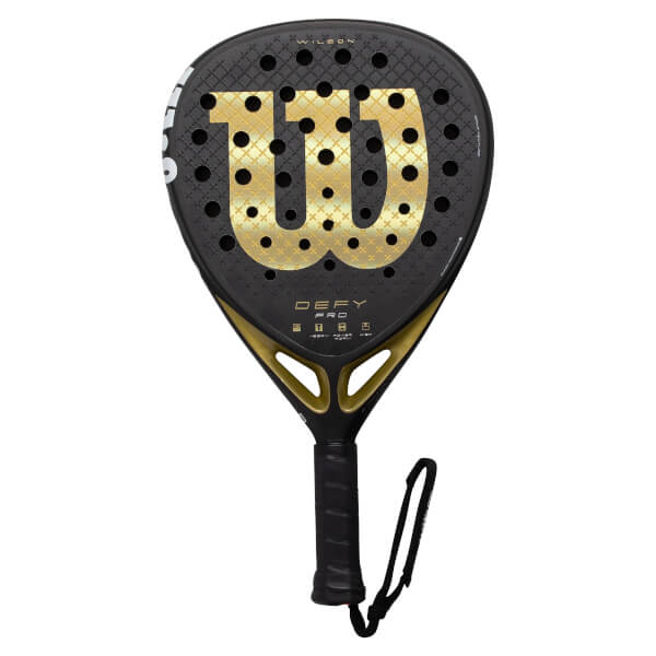 Front view of a black and gold Wilson padel racket with a large gold W logo, perforated face, and DEFY PRO text.