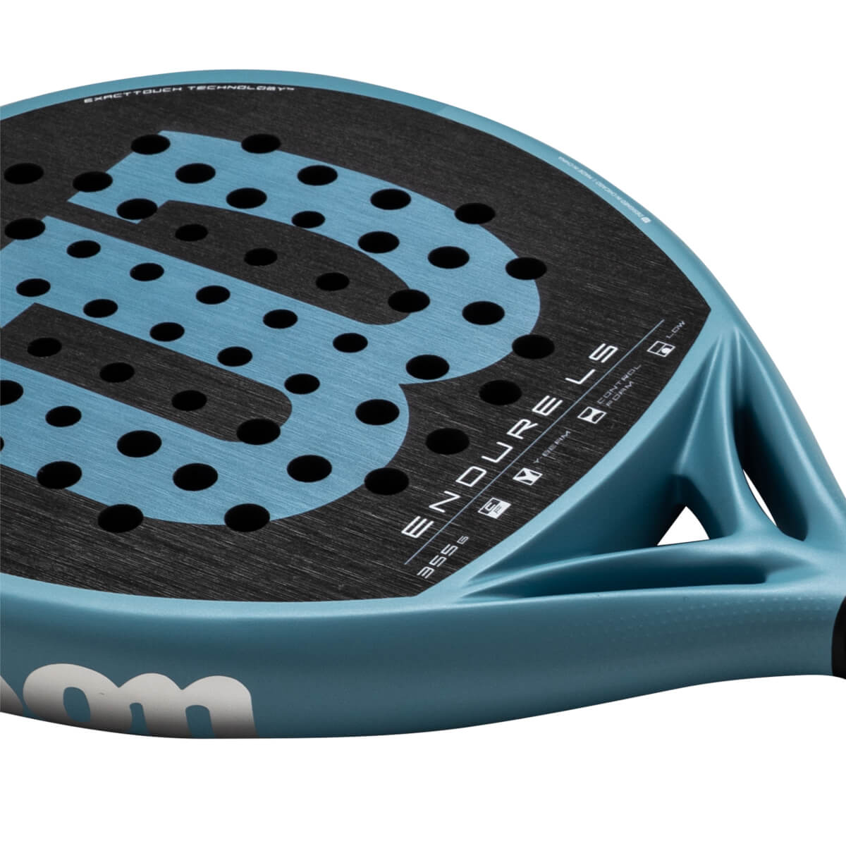 Close-up of a blue padel racket showing the "ENDURELS" text, black dots, and "EXACTTOUCH TECHNOLOGY" writing.