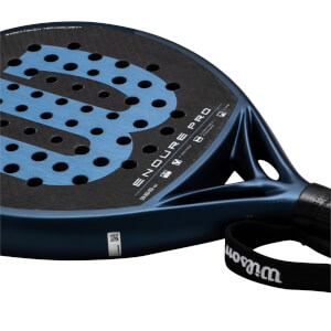 Close-up of a dark blue padel racket showing the "ENDURE PRO" text, a large blue "W" logo, and the "EXACTTOUCH TECHNOLOGY" inscription.