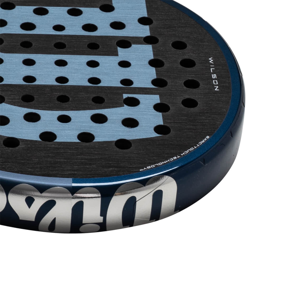 Corner view of a blue and black Wilson paddle with "WILSON" and "EXACTTOUCH TECHNOLOGY" visible.