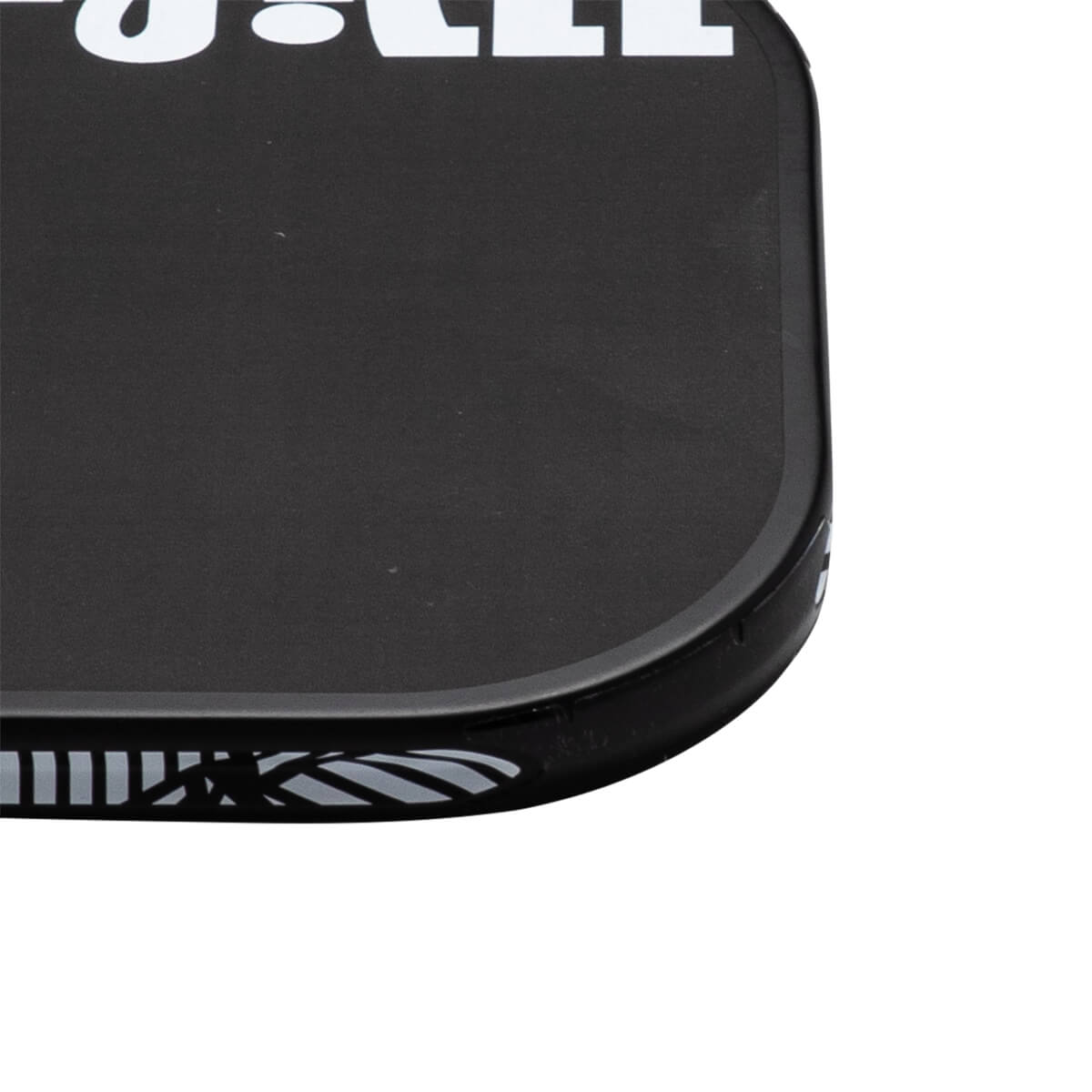 Close-up corner view of a black pickleball paddle featuring a rounded edge guard and bold white lettering along the top.
