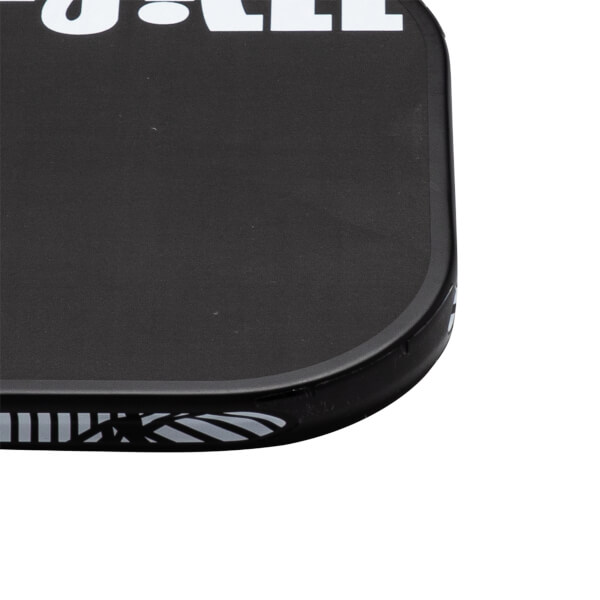 Close-up corner view of a black pickleball paddle featuring a rounded edge guard and bold white lettering along the top.