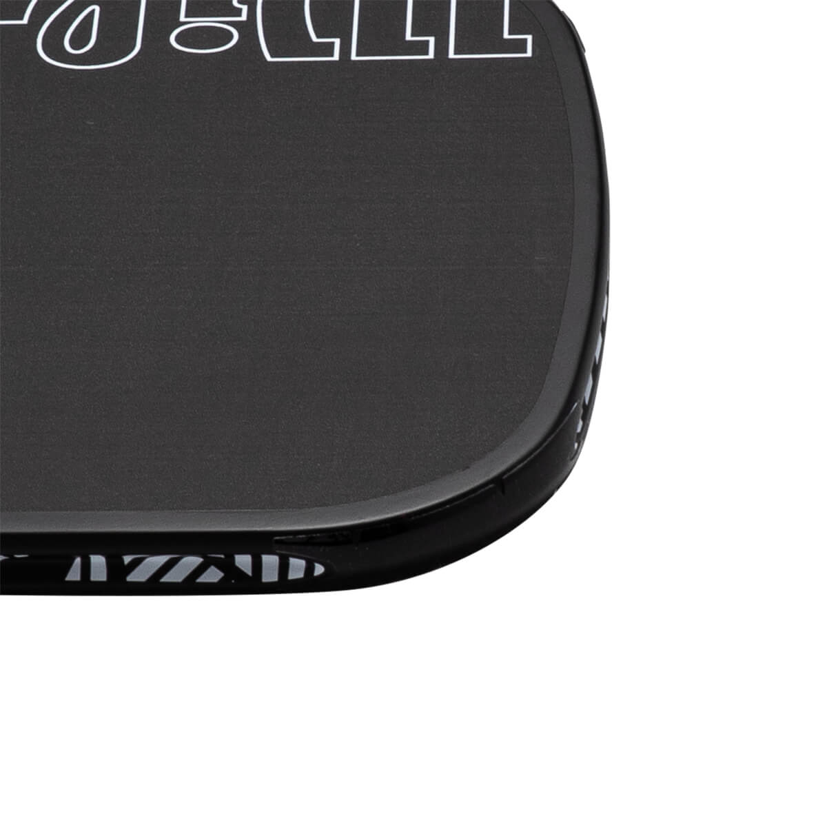 Close-up corner view of a black pickleball paddle featuring a textured surface with a white JOOLA logo outline and a patterned black edge guard.