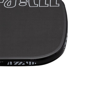 Close-up corner view of a black pickleball paddle featuring a textured surface with a white JOOLA logo outline and a patterned black edge guard.